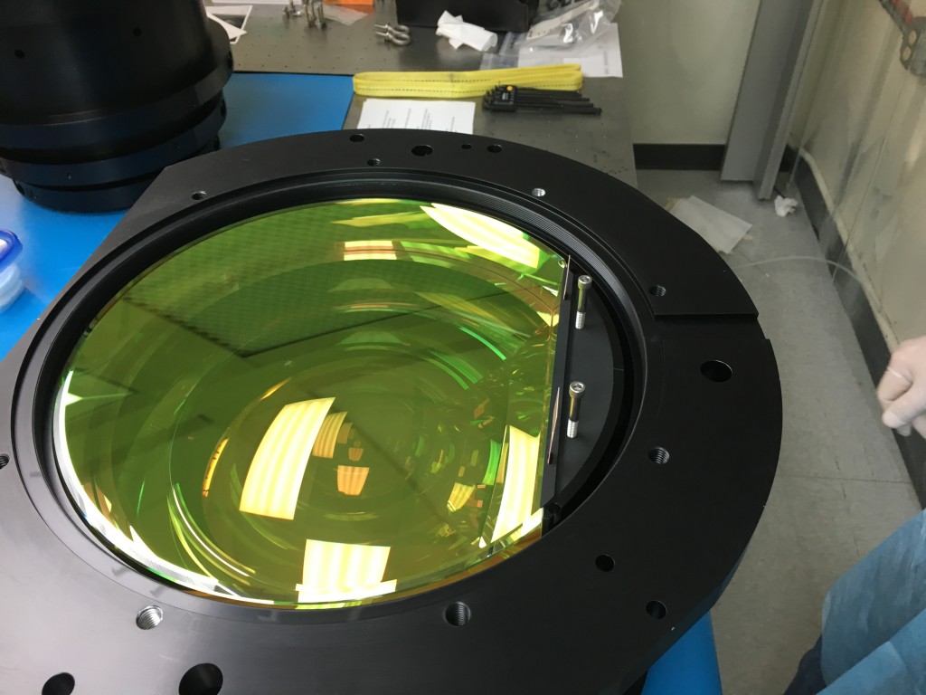 This is one of the APOGEE-2S spectrograph's lenses (there are six of them in total) up close. It is made of fused silicon, is opaque to our eyes, but is transparent to infrared light. You can see light reflecting from its surface in this photo